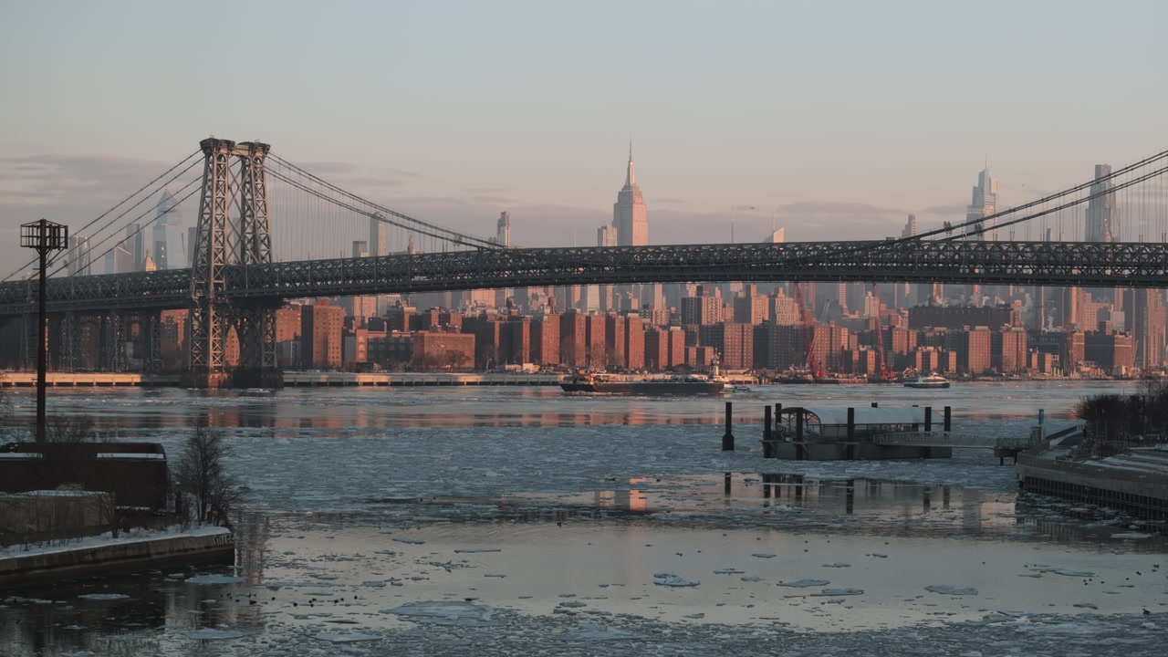 Aerial view of a freight ship on a frozen East River. Shot in New York City at sunrise.