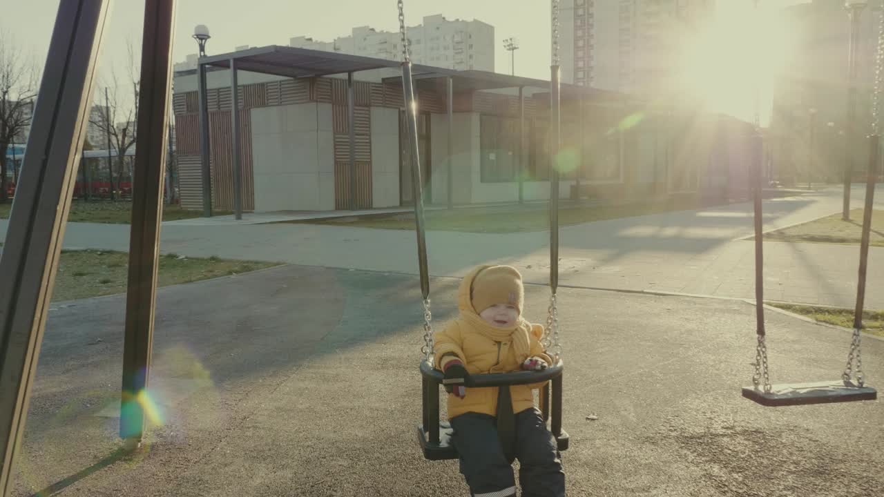 Child Playing on a Swing Set in a Park