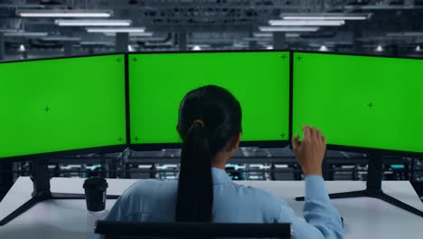 back view of tired asian woman yawning before sleeping while working with mock up multiple computer monitor in data center