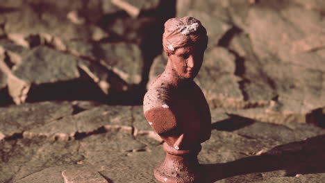 ancient-statue-of-woman-on-rocky-stones