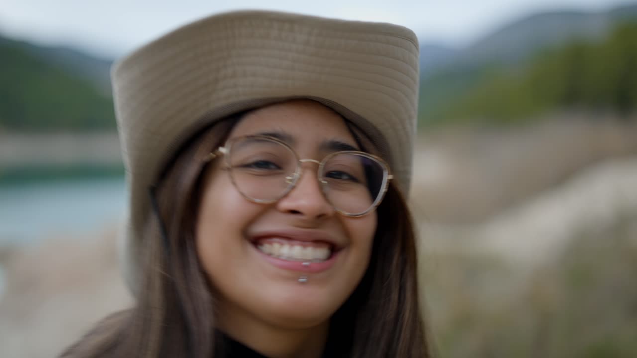 Happy Woman Hiking by a Lake