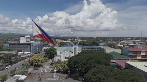 butuan skyline in caraga region mindanao philippines. the philippine flag flying proudly over the city.