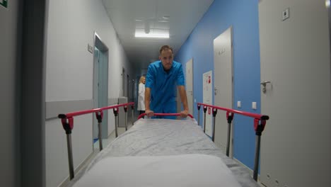 hospital corridor with nurse pushing stretcher