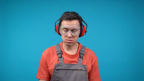 worker wearing ppe looking tired and confused