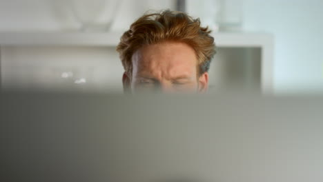 focused businessman looking computer monitor at home remote workplace closeup.