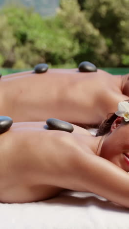 relaxed couple having hot stone massage