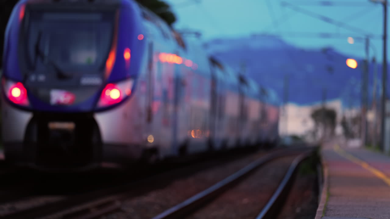 Blurred view of a train moving on the rails in the evening