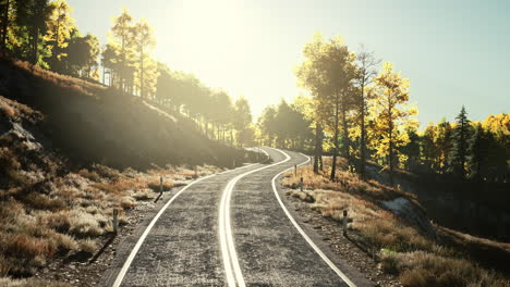 road-and-yellow-mountain-forest-at-sunset