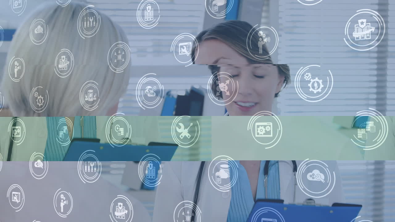 Animation of business icons over caucasian female doctor talking with her patient