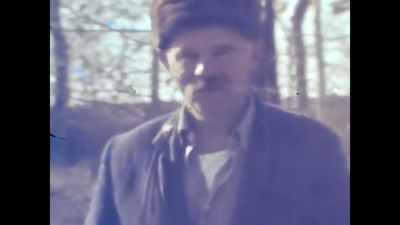 Man in Suit and Tie Standing in Front of a Window in Soviet Union. CIRCA USSR 1980s: A male figure dressed in a suit and tie stands with apparent purpose in front of a window in the Soviet Union.