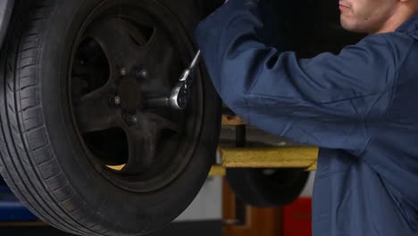 Handsome-mechanic-repairing-a-car