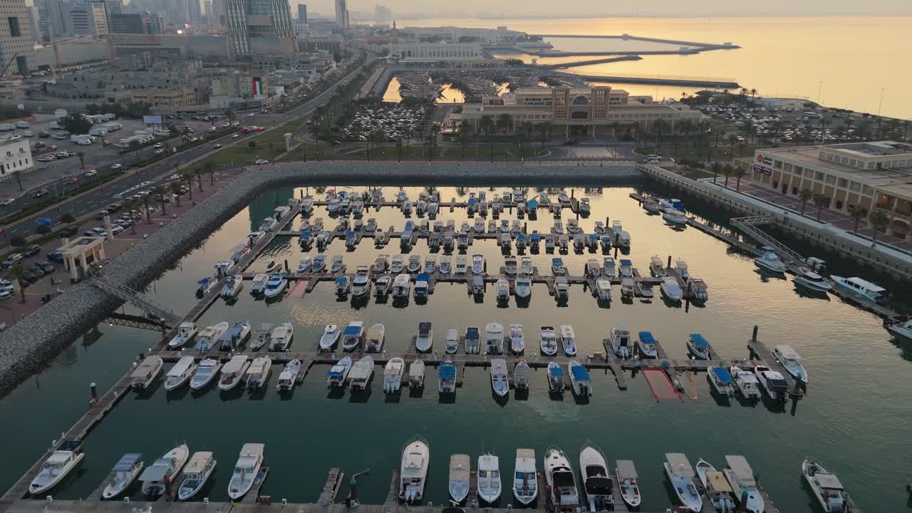 Cinematic 4K drone footage of neatly arranged boats in a marina during golden hour in Kuwait. Ideal for luxury, travel, architecture, or lifestyle content.