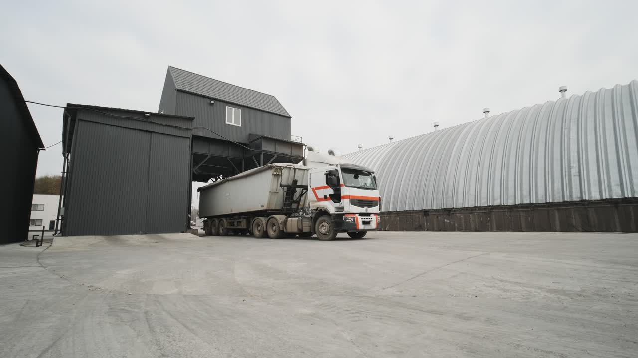 A truck with raw materials leaves the grain storage area. Car weights