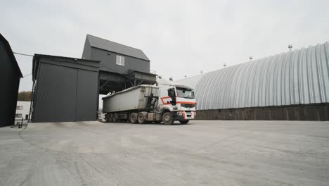 a truck with raw materials leaves the grain storage area. car weights