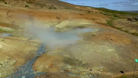 slow motion footage of hot springs, steaming fumaroles and boiling mud pots in seltun geothermal area in iceland