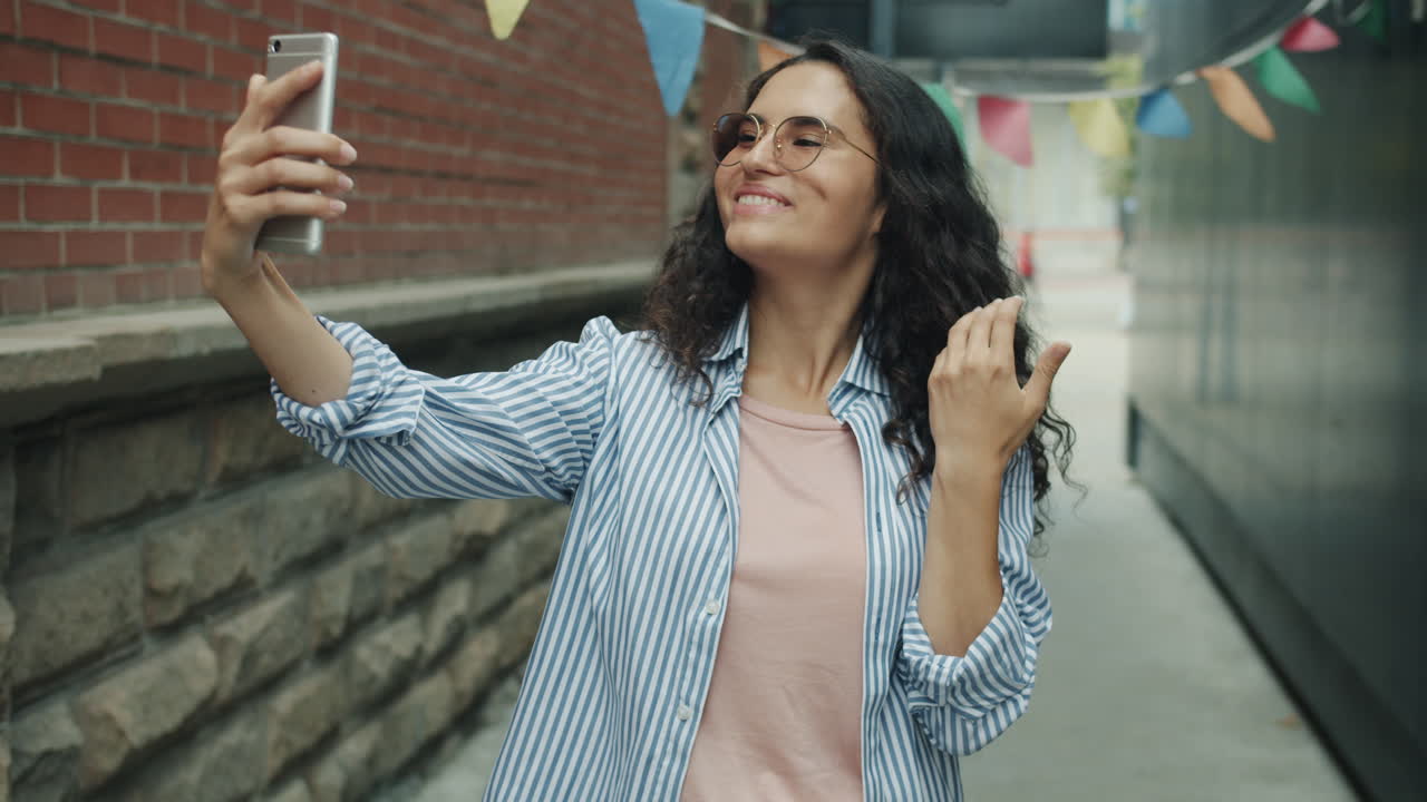 Woman Taking Selfie in City Alley