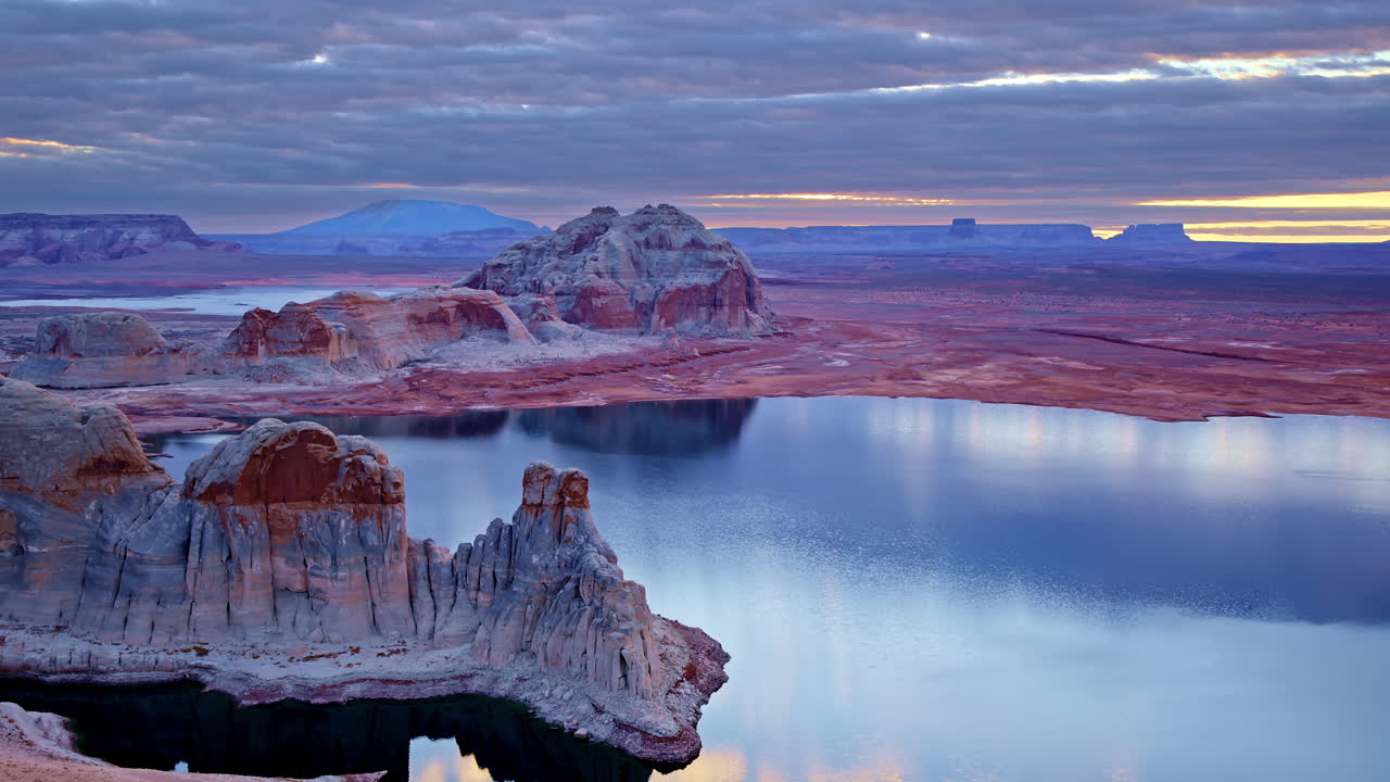 The sweeping drone view showcases Glen Canyon’s rugged cliffs and the vast, glistening waters of Lake Powell.