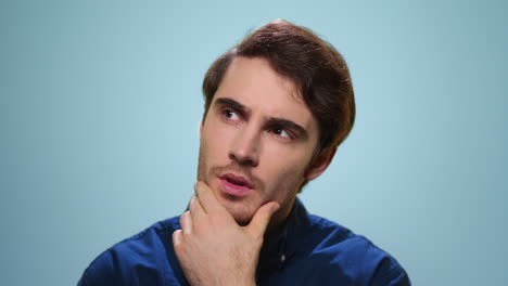 thoughtful man posing in studio. close up serious guy thinking problem solution