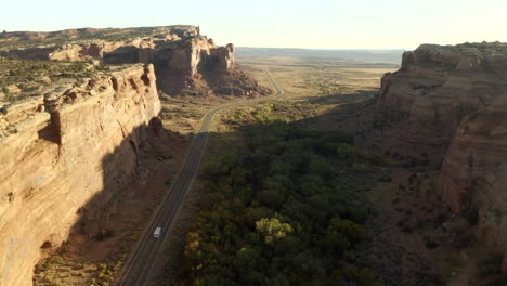 drone footage of rv driving along road between two canyons, on an epic american roadtrip in utah near canyon lands national park