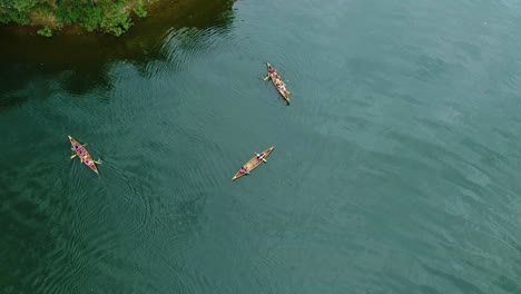 three canoes roaming the river