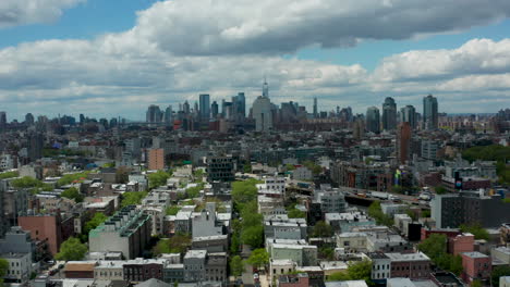 a mesmerizing drone shot gradually descends over brooklyn, revealing a captivating view towards the stunning new york city skyline