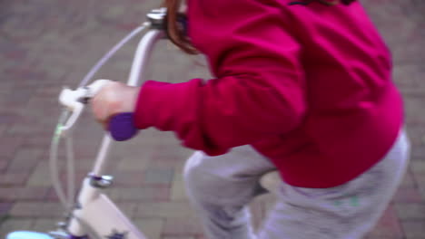 little girl riding her colorful bicycle in the backyard 4k