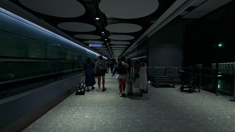 people walking through a modern train station