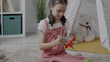 child playing with colorful puzzle blocks