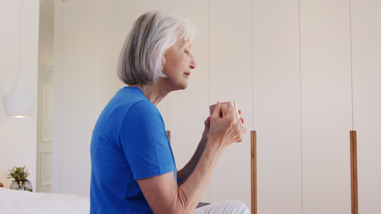 Senior woman enjoying morning coffee at home, embracing peaceful solitude, copy space