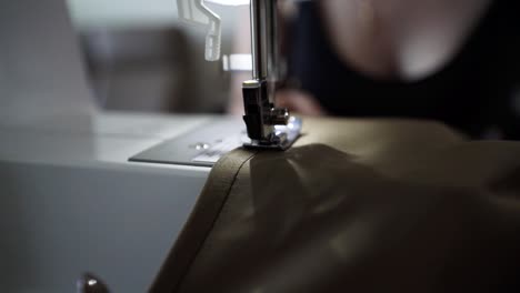 Woman-sewing-with-electric-machine,-close-up-view