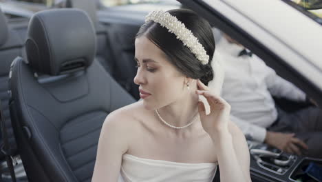 bride in a luxury convertible car on her wedding day