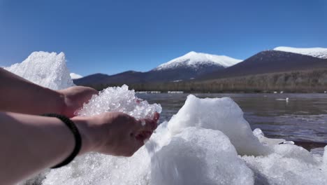 person holding ice near water