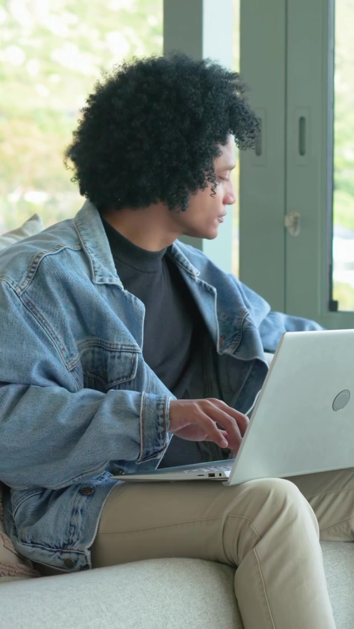 Man responding to laptop ping, typing while animated business charts emerging around hands