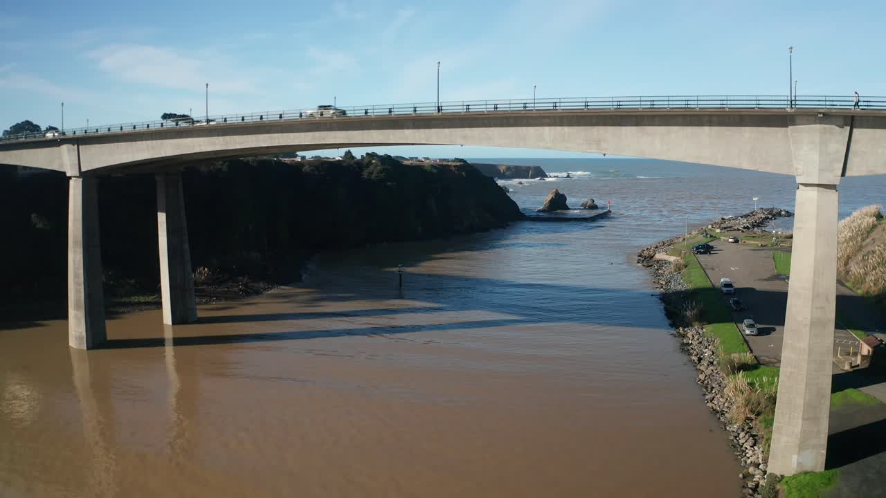 Rising aerial shot flying over the Noyo River Bridge in Fort Bragg, California. 4K