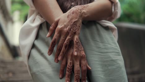 woman with henna designs on her hands