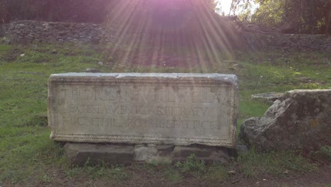 detail of a roman tomb with writings in latin along the appian way on a sunny day