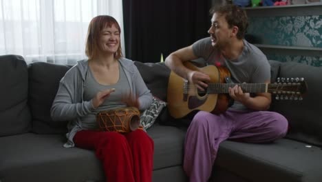 man and woman playing musical instruments at home