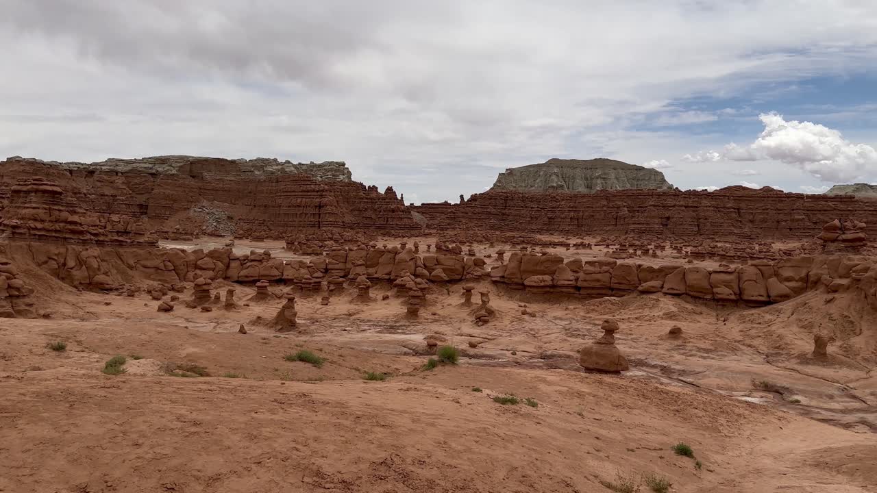 A woman walks along a hiking trail in the Mars-like landscape of Goblin Valley State Park in Utah