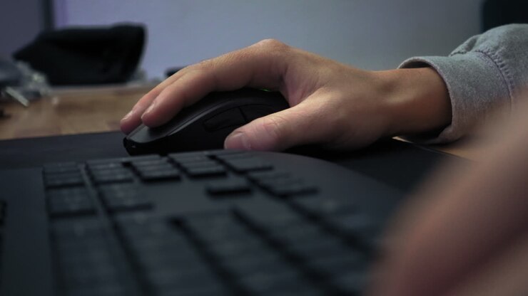 Closeup of a comuter mouse used by a male gamer