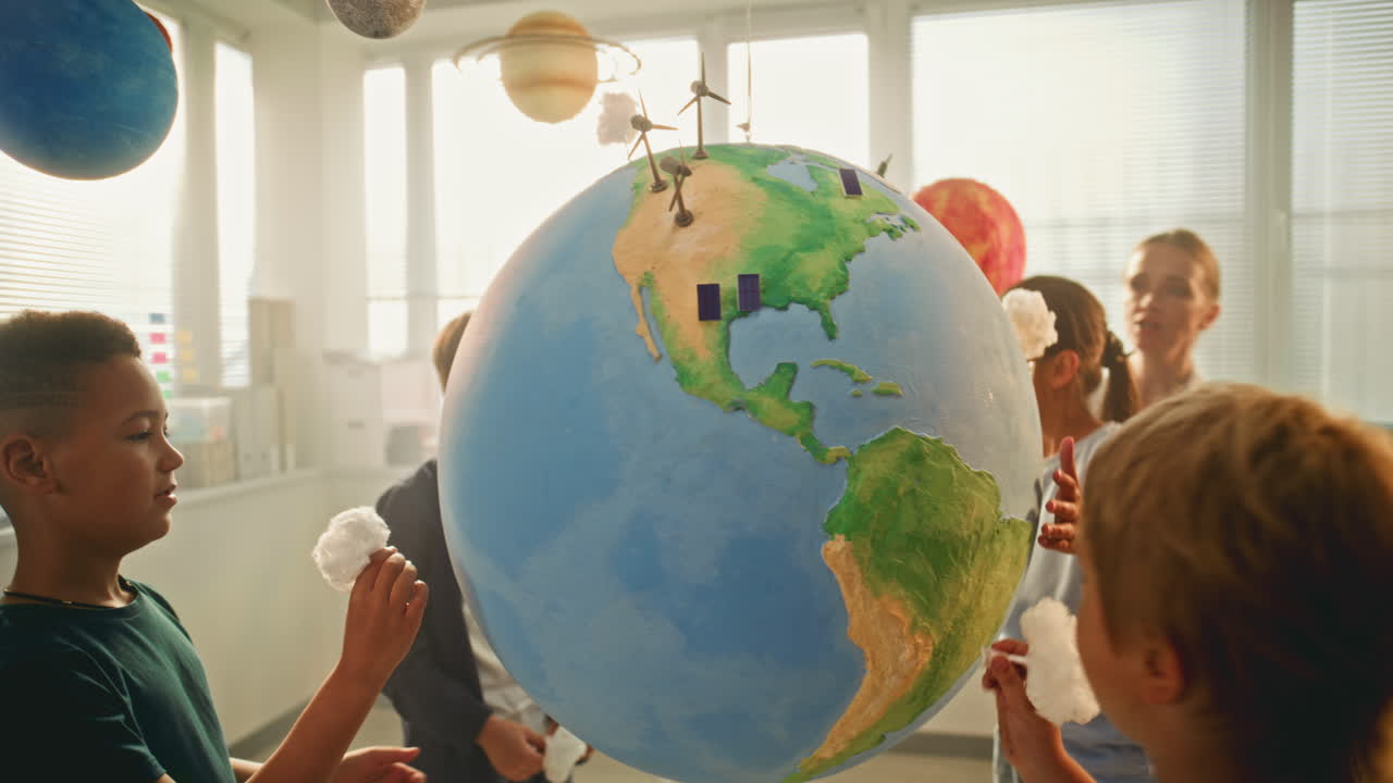 Science Lesson Primary School Children Studying Renewable Energy Using Globe
