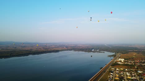hot air balloons over lake