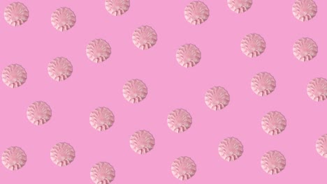 animación de bucle sin costuras de muchos malvaviscos rosados que se mueven en un fondo rosado, copia el espacio