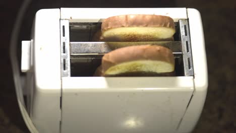 Two-Slices-Of-Wheat-Bread-Popping-Out-From-A-White-Toaster