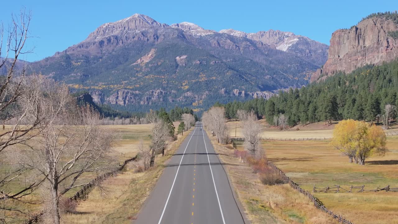 Truck travels through scenic mountain highway in Colorado, peaceful vibe