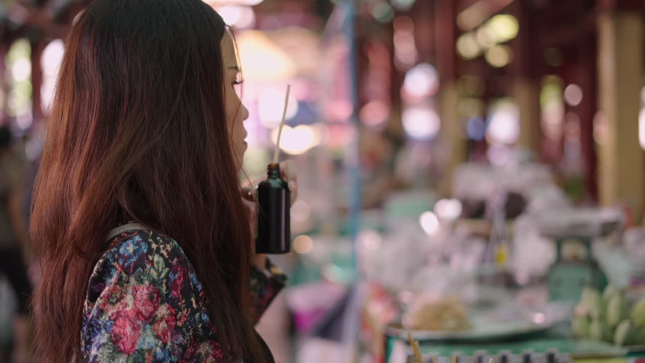 A woman smells a product at a market