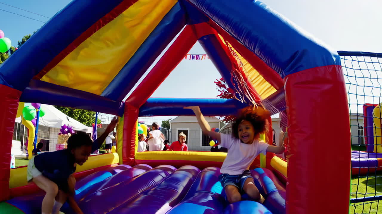 Children having fun in a bounce house at a party