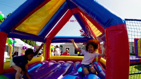 children having fun in a bounce house at a party