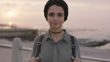 portrait of young girl with beautiful eyes looking to camera standing in seaside background