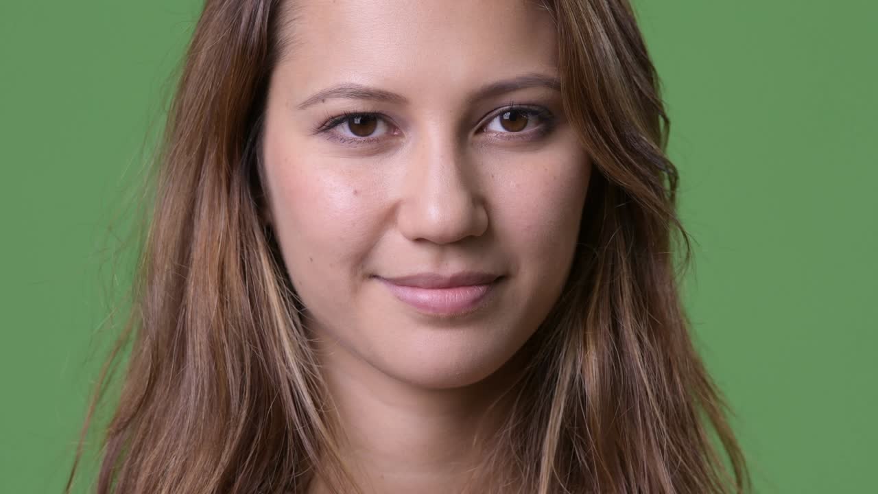 молодая красивая многоэтническая женщина на зеленом фоне