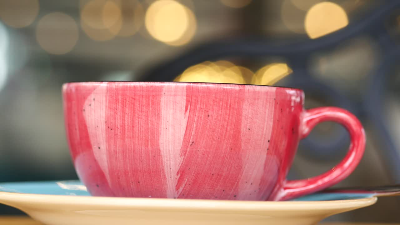 Red ceramic coffee cup on a saucer